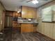 Retro kitchen with wood cabinets and a breakfast bar, perfect for casual dining at 417 Sunnyview Rd, Henderson, NC 27536