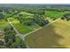 Wide aerial shot of a property, pond, cluster of trees and lush greenery, with property lines at 4240 Friendship Rock Creek Rd, Burlington, NC 27215