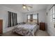 Cozy bedroom with neutral walls, carpeted floor, a ceiling fan and small windows at 4240 Friendship Rock Creek Rd, Burlington, NC 27215