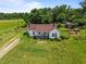 Aerial view of a well maintained one story home and surrounding green lawn at 4240 Friendship Rock Creek Rd, Burlington, NC 27215
