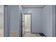 Hallway view of a tiled floor, gray trim, and an open bathroom space at 4240 Friendship Rock Creek Rd, Burlington, NC 27215