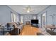 Cozy living room with a ceiling fan, wood-look floors, and a fireplace at 4240 Friendship Rock Creek Rd, Burlington, NC 27215
