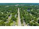 Scenic aerial view of a tree-lined neighborhood with a serene pond in the distance at 430 Walnut St, Cary, NC 27511