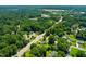 Aerial view of a neighborhood surrounded by lush greenery and mature trees at 430 Walnut St, Cary, NC 27511