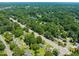 Aerial view of a residential neighborhood surrounded by lush greenery and a pond at 430 Walnut St, Cary, NC 27511