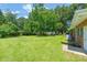 Large backyard featuring a well-manicured lawn and mature trees at 430 Walnut St, Cary, NC 27511