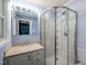 Bathroom featuring a vanity, a sink, a shower with glass doors, and light-blue walls at 430 Walnut St, Cary, NC 27511