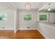 Bright dining area with hardwood floors, wainscoting, stylish light fixture, and windows offering lovely views at 430 Walnut St, Cary, NC 27511