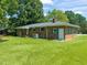 Well-maintained brick home with a large, green lawn and classic green shutters at 430 Walnut St, Cary, NC 27511