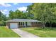 Charming brick ranch-style home with a well-manicured lawn and attached garage at 430 Walnut St, Cary, NC 27511