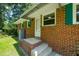 Charming brick home exterior with green shutters and a welcoming front door at 430 Walnut St, Cary, NC 27511