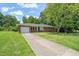 Charming brick ranch-style home with a well-manicured lawn and attached garage at 430 Walnut St, Cary, NC 27511