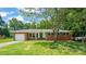 Charming brick home featuring an attached garage and a well-maintained lawn with mature trees at 430 Walnut St, Cary, NC 27511