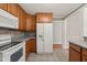 A well-lit kitchen showcases wood cabinets, a refrigerator, a microwave, and a stove at 430 Walnut St, Cary, NC 27511