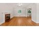 Bright living room features hardwood floors, a decorative fireplace, and neutral paint at 430 Walnut St, Cary, NC 27511