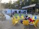 Outdoor seating area featuring yellow chairs around a fire pit, ideal for socializing at 430 Walnut St, Cary, NC 27511
