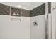 Modern shower featuring elegant white and gray tile with a built-in shelf at 430 Walnut St, Cary, NC 27511