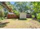 View of backyard of brick home with established trees and a large lawn at 4412 Green Spring Dr, Garner, NC 27529