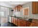 Traditional kitchen with dark countertops, wood cabinets, and view to back yard at 4412 Green Spring Dr, Garner, NC 27529