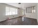 A well-lit living room with large windows and unique flooring, leading to the entryway at 4412 Green Spring Dr, Garner, NC 27529