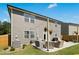A backyard patio features cushioned seating, an umbrella, and hanging flower baskets for outdoor enjoyment at 444 Campbell Ridge Pl, Wendell, NC 27591