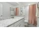 Bright bathroom featuring a granite countertop, white cabinets, and a shower with a pink curtain at 444 Campbell Ridge Pl, Wendell, NC 27591