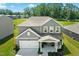 This inviting home boasts an attached two-car garage and a charming front porch with an American flag at 444 Campbell Ridge Pl, Wendell, NC 27591