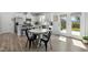 Kitchen features white cabinetry, stainless steel appliances, and granite countertops with lots of seating at 444 Campbell Ridge Pl, Wendell, NC 27591