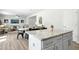 Open concept kitchen island features white cabinets with stainless steel hardware and lots of light at 444 Campbell Ridge Pl, Wendell, NC 27591