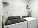Laundry room featuring a Whirlpool washer and dryer with wire shelving for storage at 444 Campbell Ridge Pl, Wendell, NC 27591