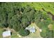 Aerial view of the home situated among lush trees at 4822 Nc Highway 98 W, Youngsville, NC 27596