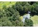 Secluded home with a green metal roof nestled among dense trees near marshland, providing privacy and natural beauty at 4822 Nc Highway 98 W, Youngsville, NC 27596