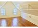 Attic space features hardwood flooring, two windows, and bright lighting at 4822 Nc Highway 98 W, Youngsville, NC 27596