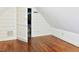 Attic area with sloped ceiling, hardwood floors, and closet storage at 4822 Nc Highway 98 W, Youngsville, NC 27596