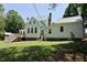 Well-maintained lawn and backyard featuring a lovely country house with stone foundation and stairs to the deck at 4822 Nc Highway 98 W, Youngsville, NC 27596
