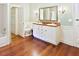 Bathroom featuring a dual sink vanity with hardwood floors and wainscoting at 4822 Nc Highway 98 W, Youngsville, NC 27596