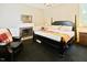 Bedroom featuring a fireplace, chair, and a comfortable bed at 4822 Nc Highway 98 W, Youngsville, NC 27596