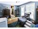 Charming bedroom with a chair, patterned rug, and an access to a porch at 4822 Nc Highway 98 W, Youngsville, NC 27596