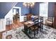 Bright dining room featuring rustic wood table, chandelier, and view to living room at 4822 Nc Highway 98 W, Youngsville, NC 27596
