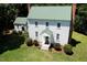 Charming two-story home features a green metal roof and white siding, surrounded by a lush green lawn at 4822 Nc Highway 98 W, Youngsville, NC 27596