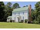 Lovely exterior view of a two story home featuring white siding and a charming green roof at 4822 Nc Highway 98 W, Youngsville, NC 27596