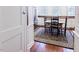 Charming kitchen with stainless steel refrigerator, white cabinetry and hardwood floors at 4822 Nc Highway 98 W, Youngsville, NC 27596