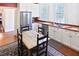 Bright kitchen featuring stainless steel appliances and hardwood floors with natural lighting at 4822 Nc Highway 98 W, Youngsville, NC 27596