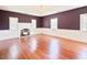 Bright living room with wood floors, fireplace, and large windows at 4822 Nc Highway 98 W, Youngsville, NC 27596