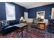 Comfortable living room with blue walls, vintage rug and furniture at 4822 Nc Highway 98 W, Youngsville, NC 27596