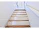Bright stairway featuring painted white risers, natural wood treads, and shiplap wall design at 4822 Nc Highway 98 W, Youngsville, NC 27596
