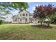 This home's backyard features a patio and lush green grass, surrounded by mature trees, perfect for entertaining at 501 Ivyshaw Rd, Cary, NC 27519