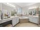 Spacious bathroom with a large soaking tub, double sink vanity, and a glass block window at 501 Ivyshaw Rd, Cary, NC 27519