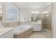 Bright bathroom with a soaking tub, a shower with a glass door, and double sink vanity at 501 Ivyshaw Rd, Cary, NC 27519