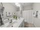 A bright bathroom includes a double vanity, neutral finishes, and great lighting at 501 Ivyshaw Rd, Cary, NC 27519